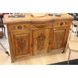 Art Nouveau oak sideboard with decorative panels, three drawers over two doors