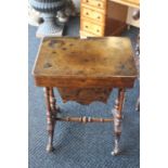 An early Victorian burr walnut sewing table, circa 1850, inlaid decoration on carved turned supports