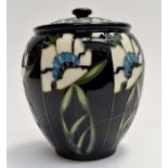 A modern Moorcroft haywood Jar and cover decorated with Houses on black ground