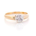 A diamond solitaire yellow gold ring, the round old cut diamond rub over set weighing approx 1
