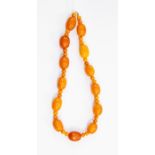 A butterscotch amber bead necklace, oval beads with smaller round bead double spacers, total gross