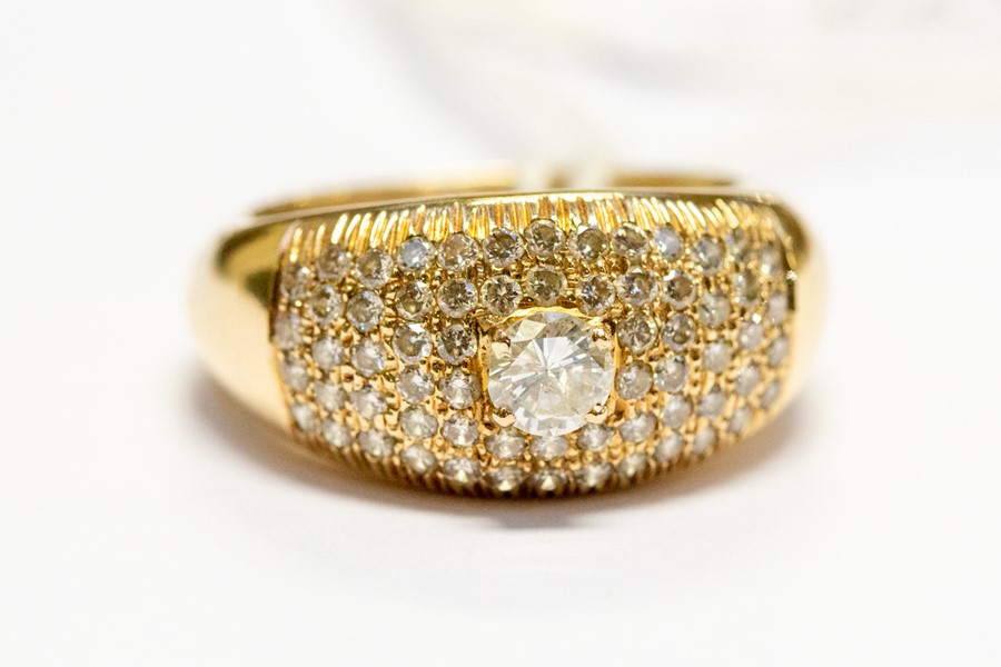 A yellow gold diamond dress ring, raised claw-set brilliant-cut to the centre approx 0.33ct, further