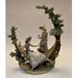 A Lladro figural group of a young girl on a hammock with a flower seller. F-11-S Condition: Damage