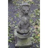 A 19th Century carved stone sculpture of a Lion, sitting on an octagonal plinth