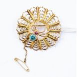 A 9ct gold brooch in the form of a spider web complete with gem-set spider, the body set with a