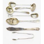 Six silver spoons, variety of sizes and makers along with sugar tongs and silver handled butter