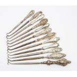 A collection of twelve 19th Century silver boot hooks
