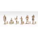 A collection of six white metal cast miniature figurines, including drummer, game hunter with