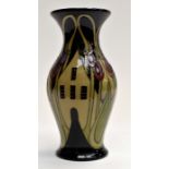 Modern Moorcroft  hamlet baluste vase decorated with dutch style houses amongst stylised flowers