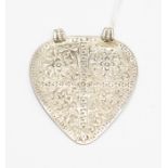 A white metal pressed, double looped ancient heart shaped hanging jewel, the decoration possibly
