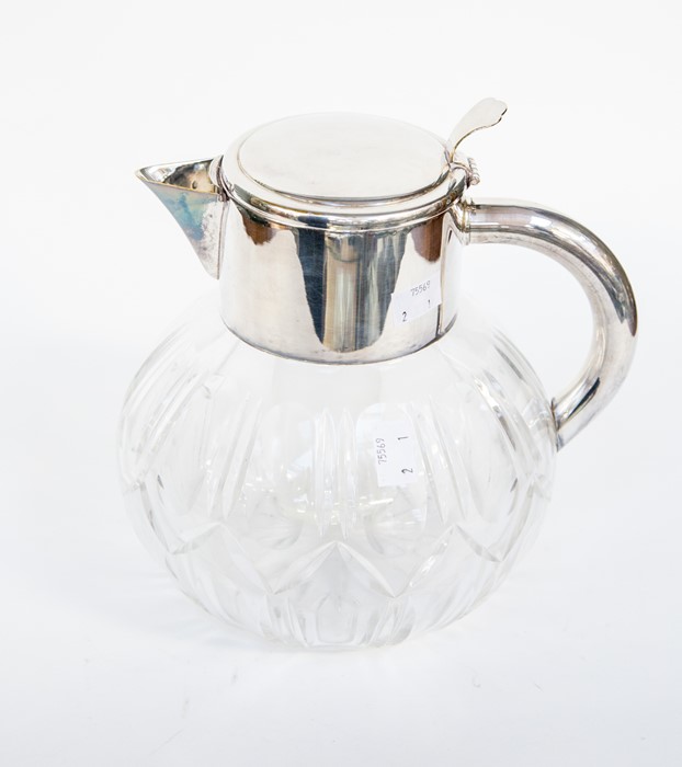 A Mappin & Webb silver plated water jug with interior glass sleeve for ice, cut glass base