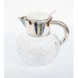 A Mappin & Webb silver plated water jug with interior glass sleeve for ice, cut glass base