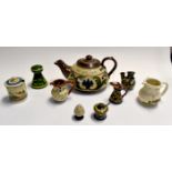 A collection of Devon Ware puzzle jugs and large teapot etc