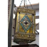 An early 20th Century ceiling light fitting with stained glass panels, brass marquetry