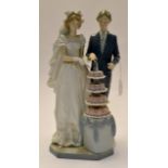 A Lladro wedding composition- study of "Cutting the Cake" bride and groom.