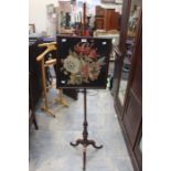 A late 19th century mahogany framed tapestry inlay pole screen on turned supports on a tripod