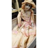 An early 1920's boudoir doll, pink dress, complete within suitcase.