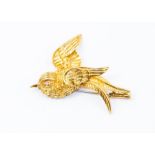 A Continental yellow gold swallow brooch with round cut ruby eye, tests as approx 14ct, approx 7.