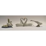 Lladro: A pair of swans in heart shape neck pose no 65085, a swan and cygnet group no 5722 and a