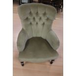 A Victorian mahogany cream upholstered nursing armchair, circa 1890, raised on turned supports.