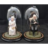 A pair of French papier mache lady and gentleman seated figures, with nodding heads, situated