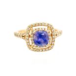 A sapphire and diamond ring, the cushion shaped purple sapphire weighing approx 1.20 carats, claw