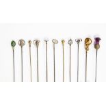 A collection of silver and gilt metal hat pins, various designs including a mother of pearl and