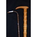 A pair of wooden walking canes, bamboo pattern