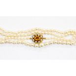 A graduated pearl necklace with citrine and pearl set clasp