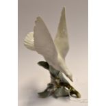 A Lladro study of a Seagull resting on a berried branch- with paperwork