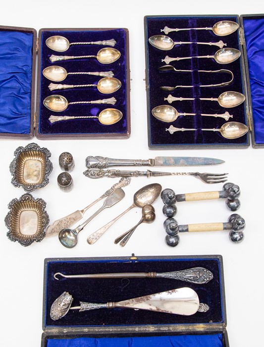 A collection of cased silver spoons, silver handled shoe horn and hook spoons, knives and other