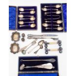 A collection of cased silver spoons, silver handled shoe horn and hook spoons, knives and other