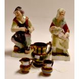 Large 19th Century Staffordshire figures of The Cobbler and His Wife, plus three Staffordshire jugs