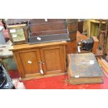 A 19th Century family Bible with two brass clasps, one loose, on oak smokers cabinet, a wooden