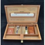 Mid century wooden cigar humidor case with miscellaneous smoking items within.