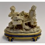 French bisque figure group of a boy pushing a girl in a wheelbarrow, on stand