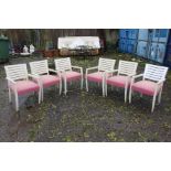 A set of six 1950's style white painted dining chairs with pink upholstered seats.