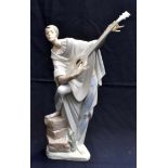 A Lladro figurine in theatrical costume- a male lute player