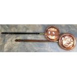 A pair of copper bed warmers