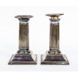 A pair of silver plated candlesticks, beaded border