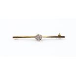 An Edwardian 18ct yellow gold and diamond bar brooch, set with seven round old-cut diamonds, stamped