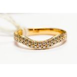 A diamond set 18ct rose gold ring, the shaped half hoop band grain set with a double row of a