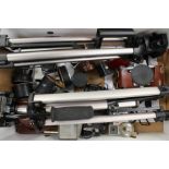 Collection of cameras and accessories including tripods.