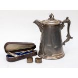 A large claret, silver plated Victorian jug with American cased grape spoon and silver napkin rings