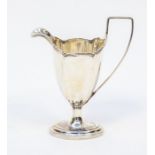 A silver cream jug, 14cm high, London 1901, 109.7gms