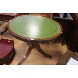 A 19th Century style mahogany circular library table, green leather inlay top on a turned column,