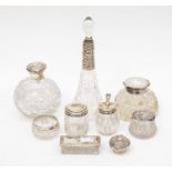 A collection of silver topped glass scent bottles, trinket dishes and glass plus a silver topped