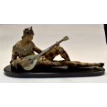 A large Lladro study of "Harlequin" playing a lute. Brown tinted glaze, matt and gloss glazing.