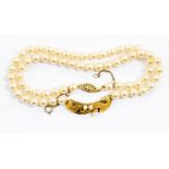 A cultured pearl necklace with 9ct gold pendant detail set with small pearls