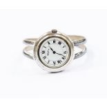 A Roy King watch with circular dial, Roman numerals, sterling silver bangle strap (glass is